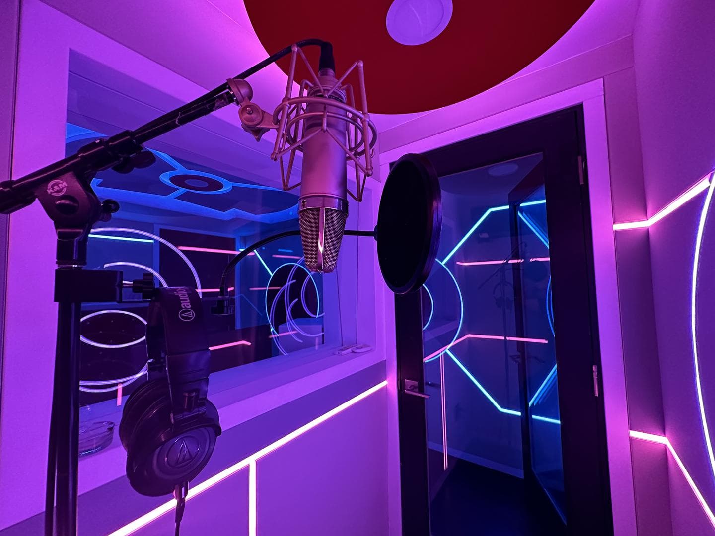 The Vault at Weddington Studios, one of three rooms running the Neumann U87 vocal mic, lit by geometric neon